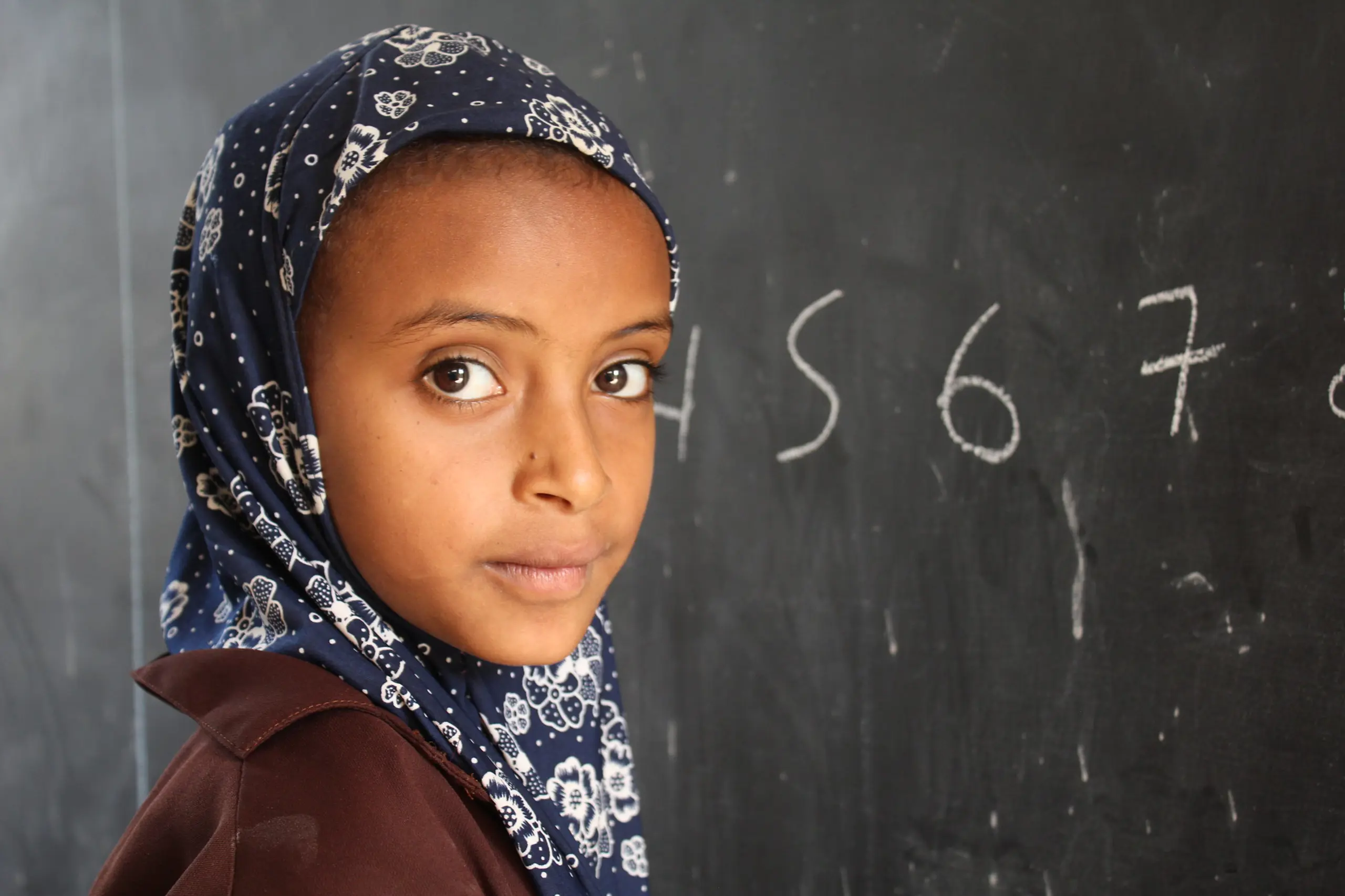 A girl student in front of the blackboard at an Elementary School in Ethiopia